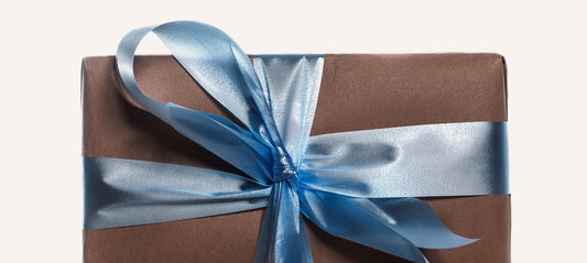 A beautifully wrapped gift with a blue ribbon