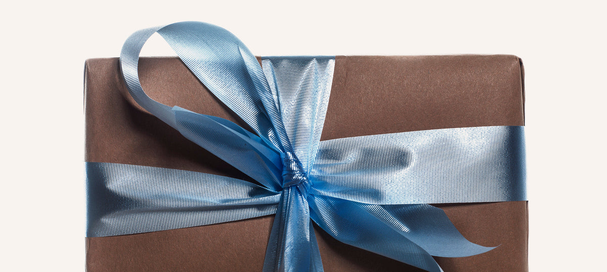 A beautifully wrapped gift with a blue ribbon
